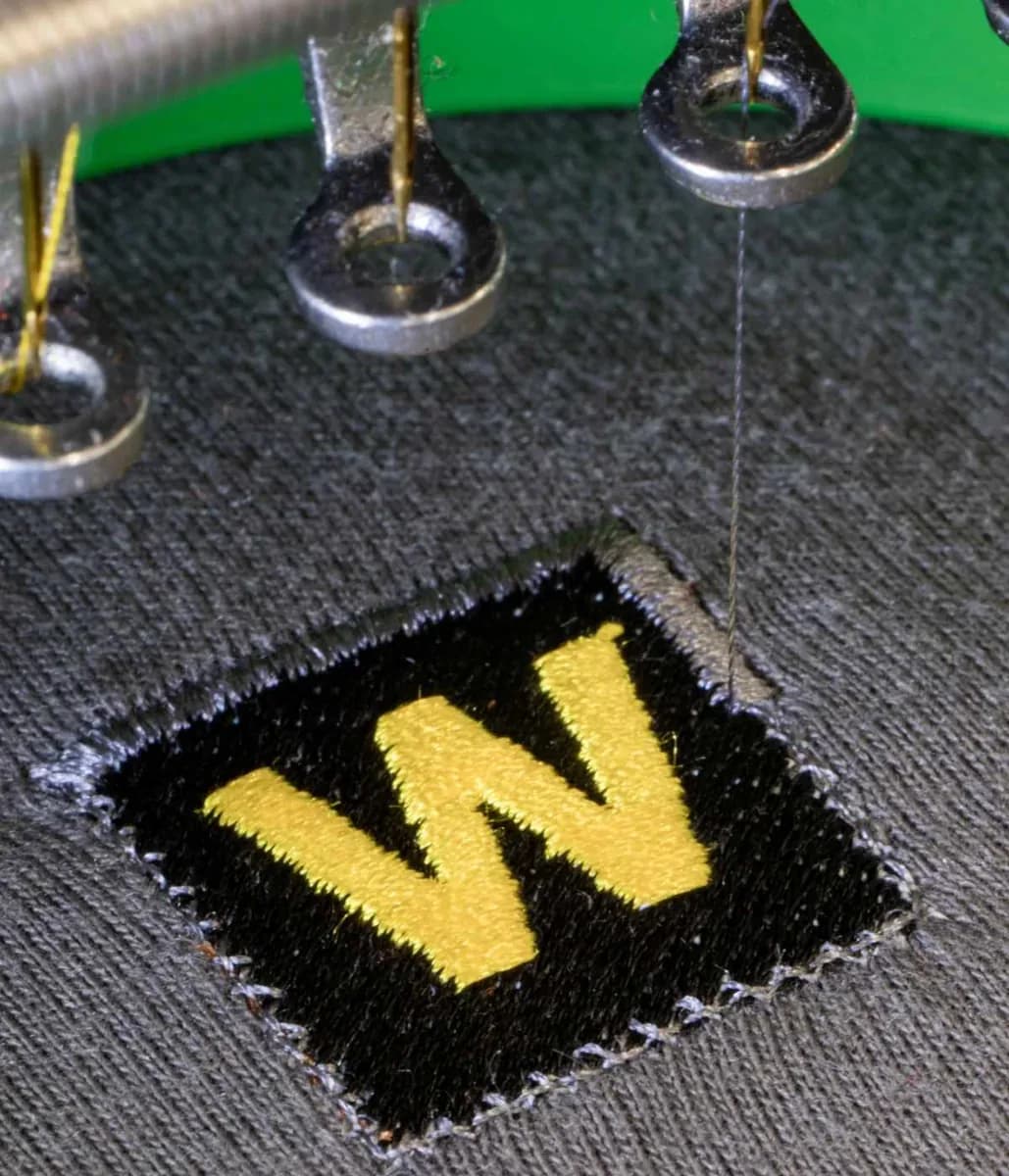 Industrial embroidery machine stitching company logo onto workwear — embroidery Wembley